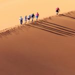 People Climbing A Dune In Sossusvlei Namibia